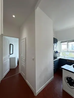 a kitchen with a large white wall in the middle at Cannes Suquet by Welcome to Cannes in Cannes