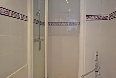 a shower with a glass door in a bathroom at Palais Alexandre III in Cannes
