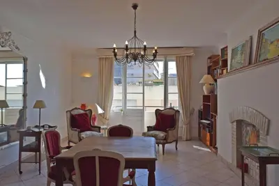 a living room with a table and chairs and a fireplace at Palais Alexandre III in Cannes