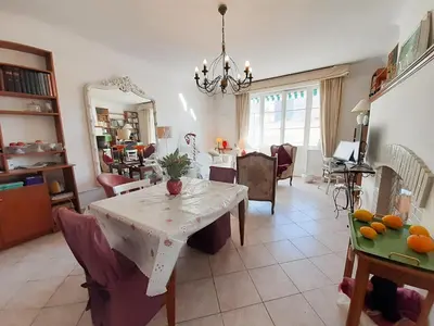 a living room with a table and a dining room at Palais Alexandre III in Cannes