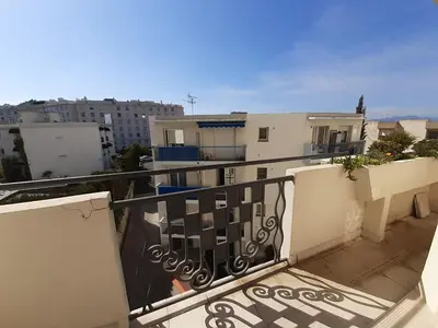 a balcony with a view of some buildings at Palais Alexandre III in Cannes