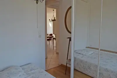 a bedroom with two beds and a mirror at Palais Alexandre III in Cannes