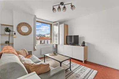 a living room with a couch and a tv at Cosy Studio, Cannes centre in Cannes