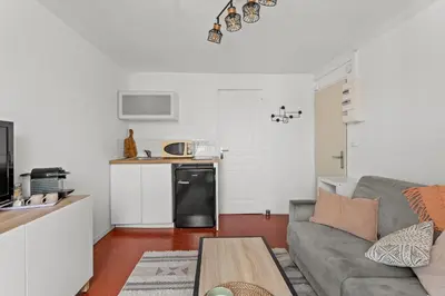 a living room with a couch and a kitchen at Cosy Studio, Cannes centre in Cannes