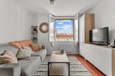 a living room with a couch and a tv at Cosy Studio, Cannes centre in Cannes