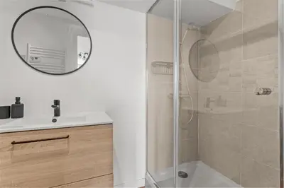 a bathroom with a shower and a sink and a mirror at Cosy Studio, Cannes centre in Cannes