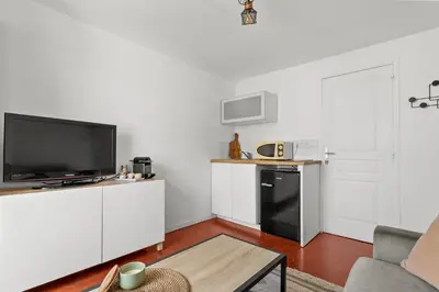 a living room with a tv and a kitchen at Cosy Studio, Cannes centre in Cannes