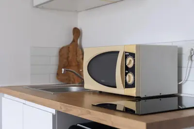 a microwave sitting on top of a kitchen counter at Cosy Studio, Cannes centre in Cannes