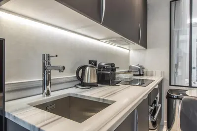 a kitchen with a sink and a counter top at Résidence Topaze - Central - Luxurious - 50m Croisette Palais - LRA CANNES in Cannes