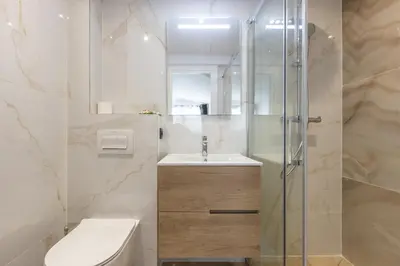 a bathroom with a shower and a toilet and a sink at Résidence Topaze - Central - Luxurious - 50m Croisette Palais - LRA CANNES in Cannes