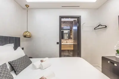 a bedroom with a white bed and a mirror at Résidence Topaze - Central - Luxurious - 50m Croisette Palais - LRA CANNES in Cannes