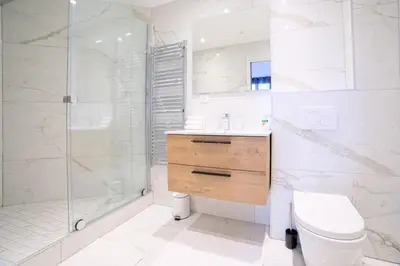 a bathroom with a shower and a toilet and a sink at L'Elégance Hoche - Congrès Palais - Plage Croisette - Cannes Centre - Clim in Cannes