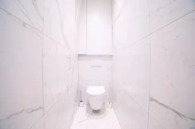 a white bathroom with a white toilet in a room at L'Elégance Hoche - Congrès Palais - Plage Croisette - Cannes Centre - Clim in Cannes