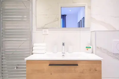 a bathroom with a sink and a mirror at L'Elégance Hoche - Congrès Palais - Plage Croisette - Cannes Centre - Clim in Cannes