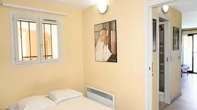 a bedroom with a bed and a picture on the wall at Appartement 607, vue mer, 4 personnes By Palmazur Vacances in Cannes