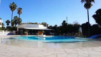 a swimming pool with blue water in front of a building at Appartement 607, vue mer, 4 personnes By Palmazur Vacances in Cannes
