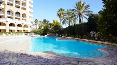 a swimming pool in front of a building at Appartement 607, vue mer, 4 personnes By Palmazur Vacances in Cannes