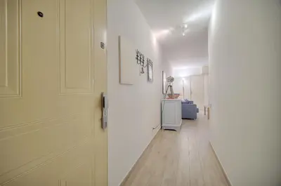 a hallway with a door and a room with a table at Super Central Cannes - all comfort - Calm in Cannes