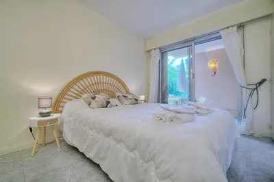 a bedroom with a large white bed with a window at Super Central Cannes - all comfort - Calm in Cannes