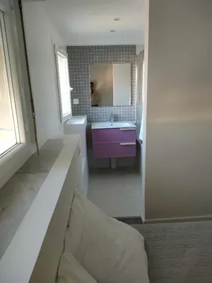 a bathroom with a purple sink and a purple cabinet at 3 rooms, 2 bathrooms, in a villa. Lightfull, quiet and charm in Cannes