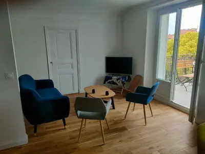 a living room with chairs and a table and a television at 3 rooms, 2 bathrooms, in a villa. Lightfull, quiet and charm in Cannes