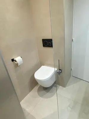 a bathroom with a toilet and a glass shower stall at Luxury studio in Cannes
