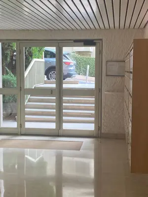 an open door to a patio with a car outside at Luxury studio in Cannes