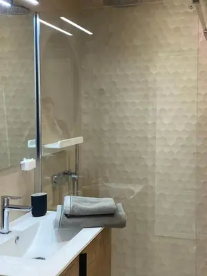 a bathroom with a sink and a glass shower at Luxury studio in Cannes