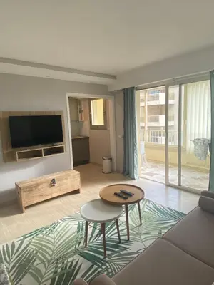 a living room with a couch and a table at Luxury studio in Cannes