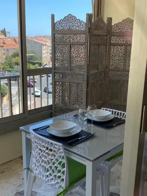 a white table with two glasses on a balcony at Luxury studio in Cannes