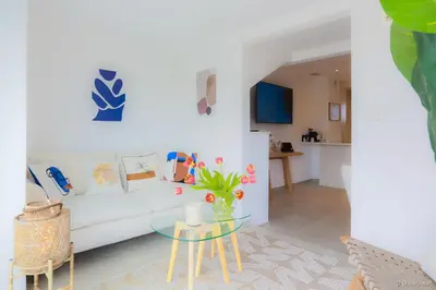 a living room with a white couch and a glass table at LOFT CROISETTE VUE Mer in Cannes