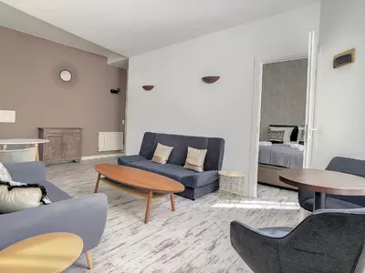 a living room with a blue couch and tables at 2 Bedroom luxury flat Cannes Center La Croisette in Cannes