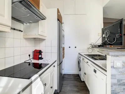 a kitchen with white cabinets and a red appliance on a counter at 2 Bedroom luxury flat Cannes Center La Croisette in Cannes