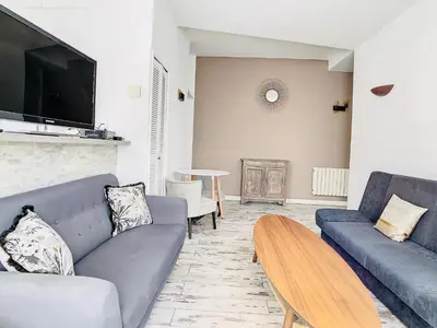 a living room with two couches and a tv at 2 Bedroom luxury flat Cannes Center La Croisette in Cannes