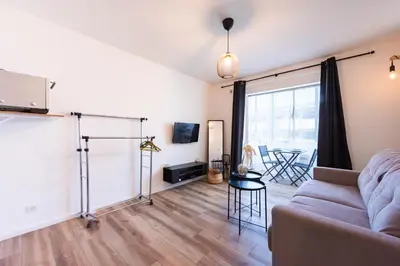 a living room with a couch and a table at Appartement bord de mer in Cannes
