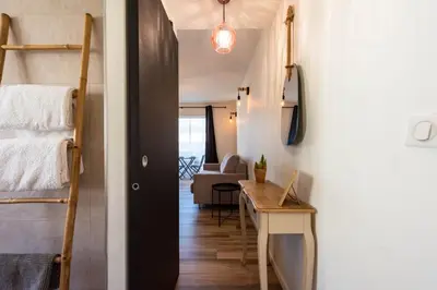 a small room with a bunk bed and a desk at Appartement bord de mer in Cannes