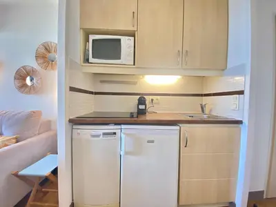 a small kitchen with a refrigerator and a microwave at Les Ingres By SCLS Locations in Cannes