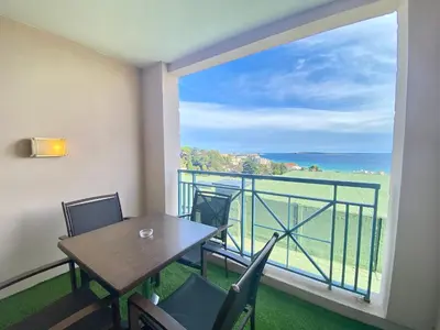 a balcony with a table and chairs and a view of the ocean at Les Ingres By SCLS Locations in Cannes