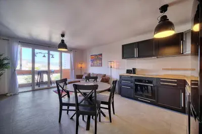 a kitchen and dining room with a table and chairs at IMMOGROOM - Renovated - Loggia - Clear view - Parking common - AC - Wifi in Cannes