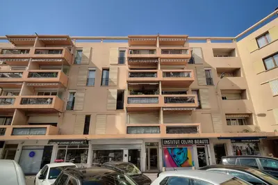 an apartment building with cars parked in front of it at IMMOGROOM - Renovated - Loggia - Clear view - Parking common - AC - Wifi in Cannes