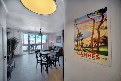a living room with a large poster on the wall at IMMOGROOM - Renovated - Loggia - Clear view - Parking common - AC - Wifi in Cannes