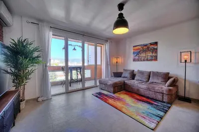 a living room with a couch and a large window at IMMOGROOM - Renovated - Loggia - Clear view - Parking common - AC - Wifi in Cannes