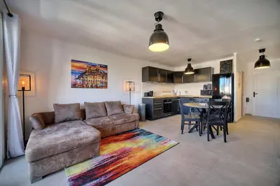 a living room with a couch and a table at IMMOGROOM - Renovated - Loggia - Clear view - Parking common - AC - Wifi in Cannes