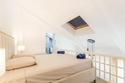 a bedroom with two beds and a tv on the wall at LB Vacation Rentals I Duplex Commandant Andre 65m2 I Casa d'Azur in Cannes