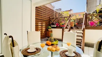 a glass table with food on top of a balcony at Cannes : superbe terrasse rue d'Antibes in Cannes