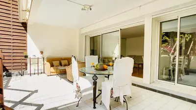 a living room with a table and chairs at Cannes : superbe terrasse rue d'Antibes in Cannes