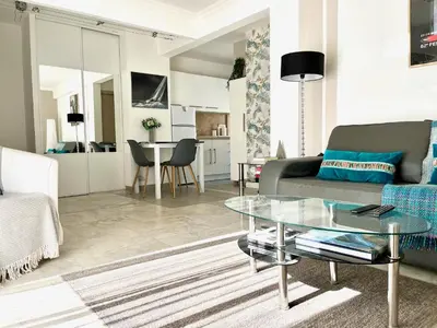 a living room with a couch and a table at Palais Lumière in Cannes