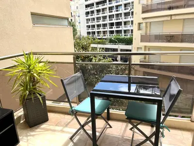 a balcony with a table and chairs on a balcony at Palais Lumière in Cannes