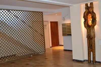 a hallway with a room with a metal wall at Palais Lumière in Cannes