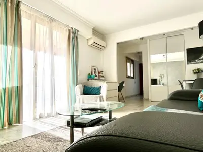a living room with a bed and a glass table at Palais Lumière in Cannes